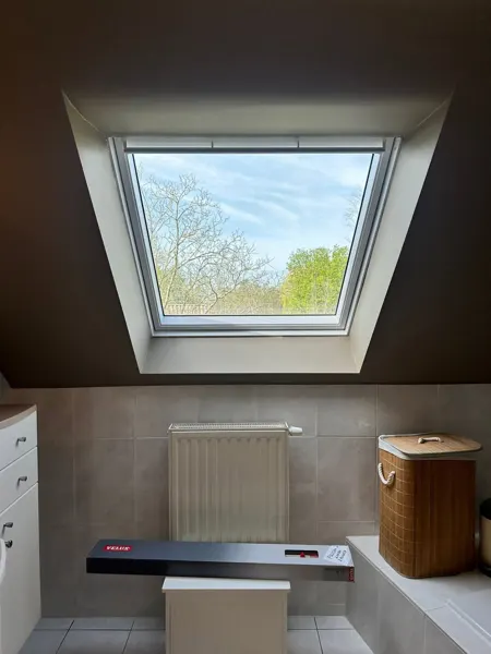 Geopend Velux-dakraam met afgewerkte binnenzijde – dakwerk door Prodak, Temse