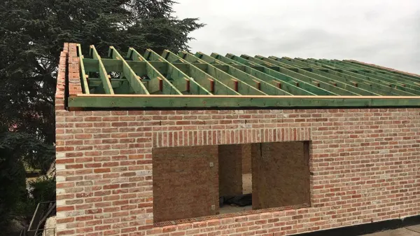 Daktimmerwerk met gedrenkte kepers op een bijgebouw in recuperatiesteen – dakwerk door Prodak, Temse